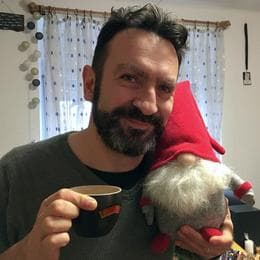 Tamás Hajas cheers holding an elf puppet.